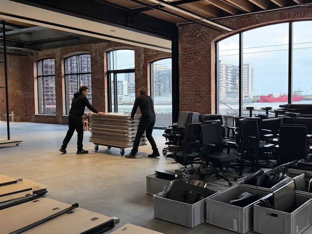 Dismantled desks and packed monitors on an office floor on the Eilandje during an office clearance in Antwerpen